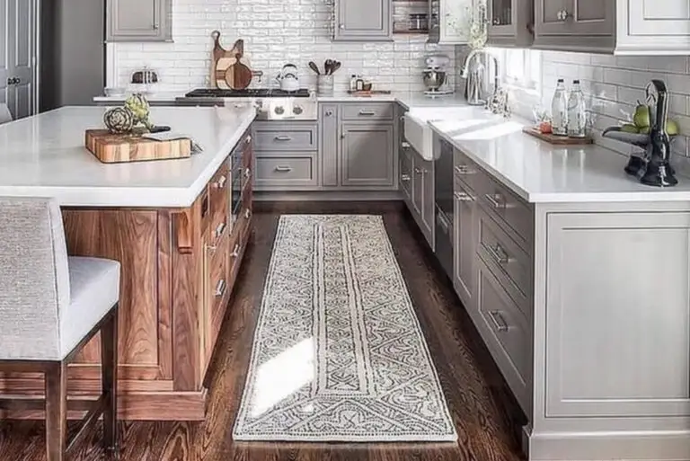 Remodeled kitchen with gray shaker cabinets, a walnut island, white subway tile backsplash, and a farmhouse sink