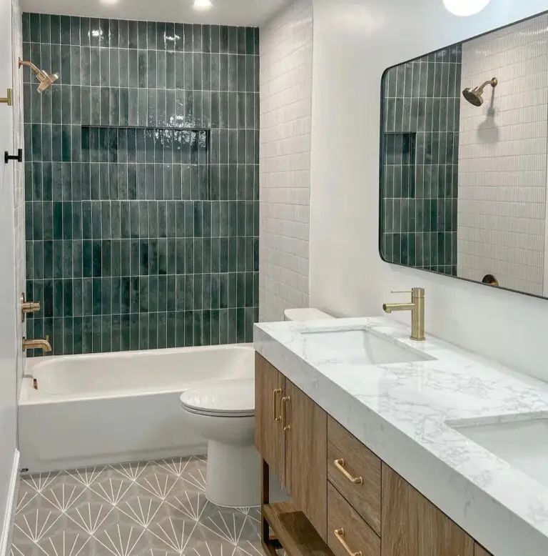 Bathroom remodel with a green vertical tile tub surround and a marble-top vanity